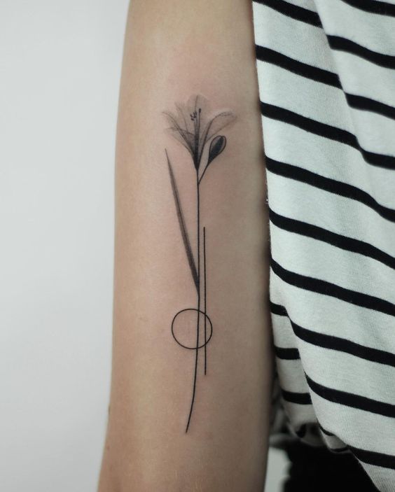 fine black and gray flower tattoo on upper arm