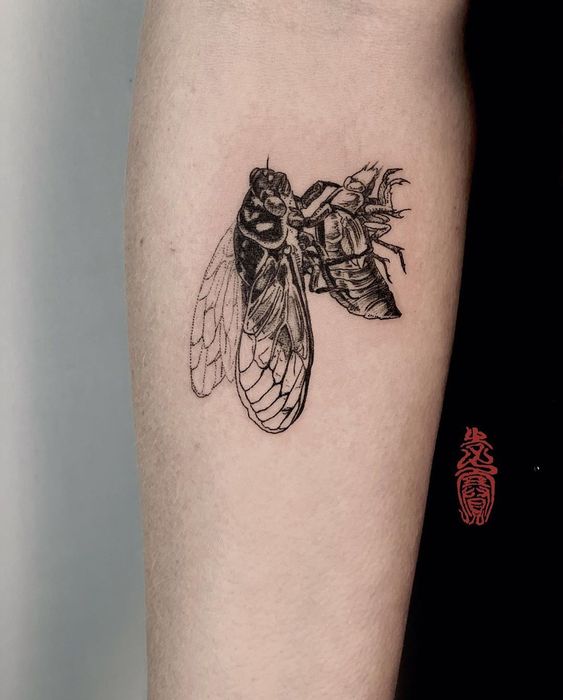 insect forearm tattoo