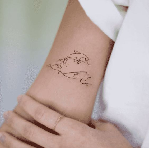 simple and beautiful dolphin tattoo