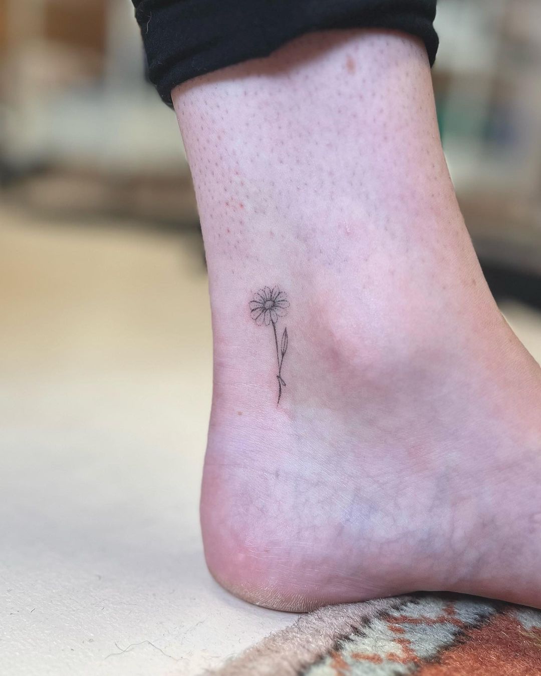 small flower tattoo on feet for men by pokesbyamy