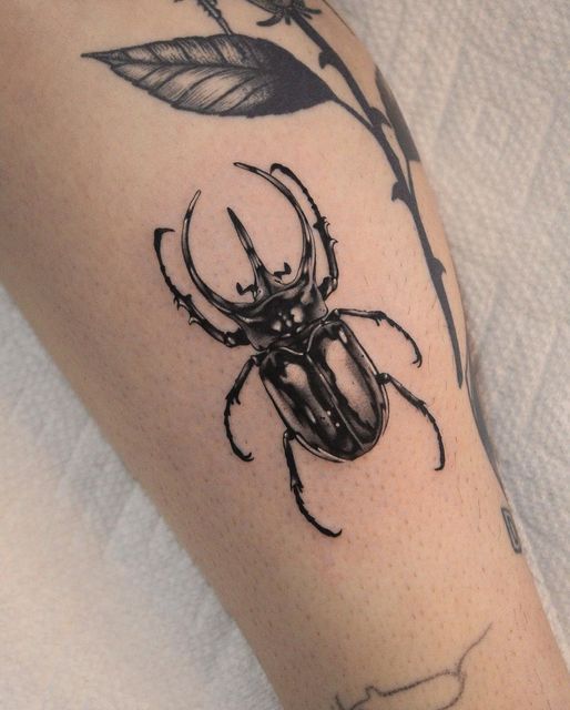 small insect tattoo on arm