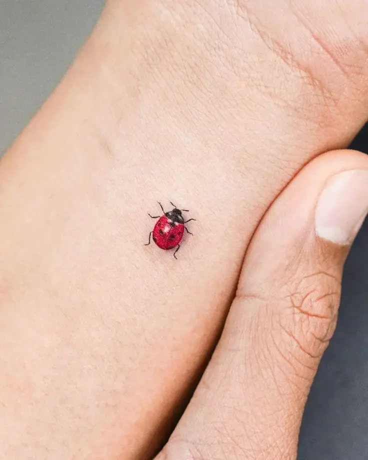 small insect tattoo