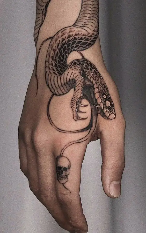 snake on hand tattoo