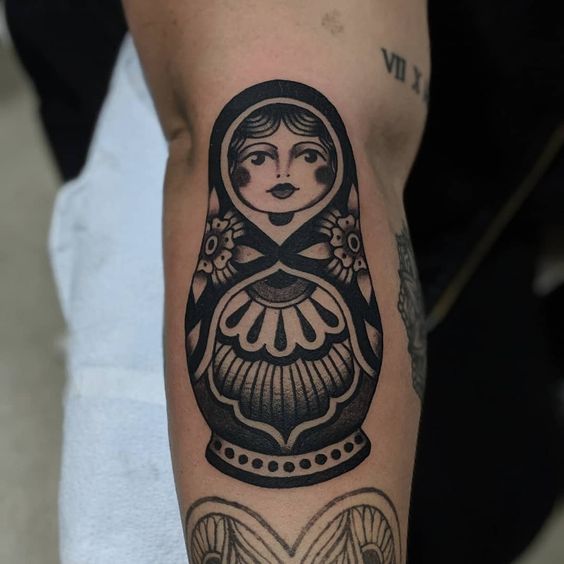 traditional doll tattoos in arm