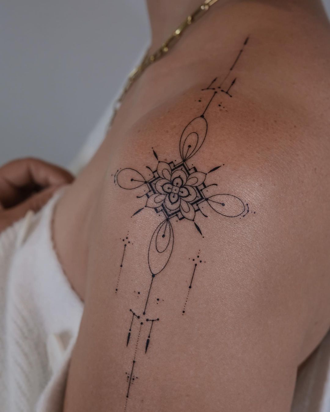 Geometric tattoos on shoulder by monochrom.ink