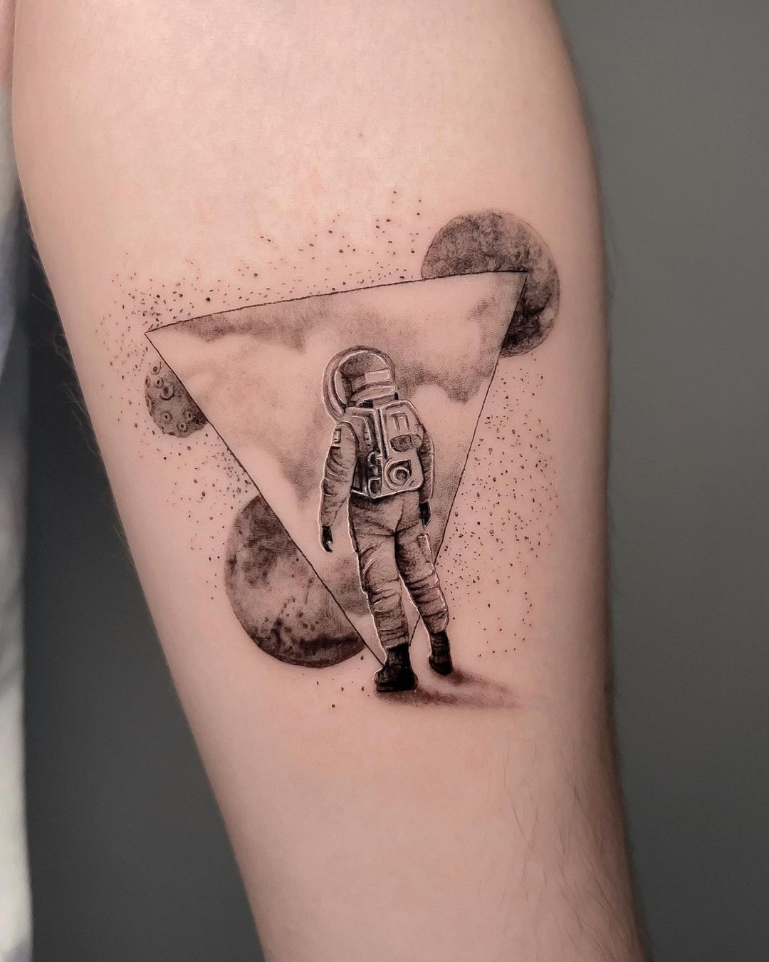astronaut on forearm tattoo by ivanruotolo.ink