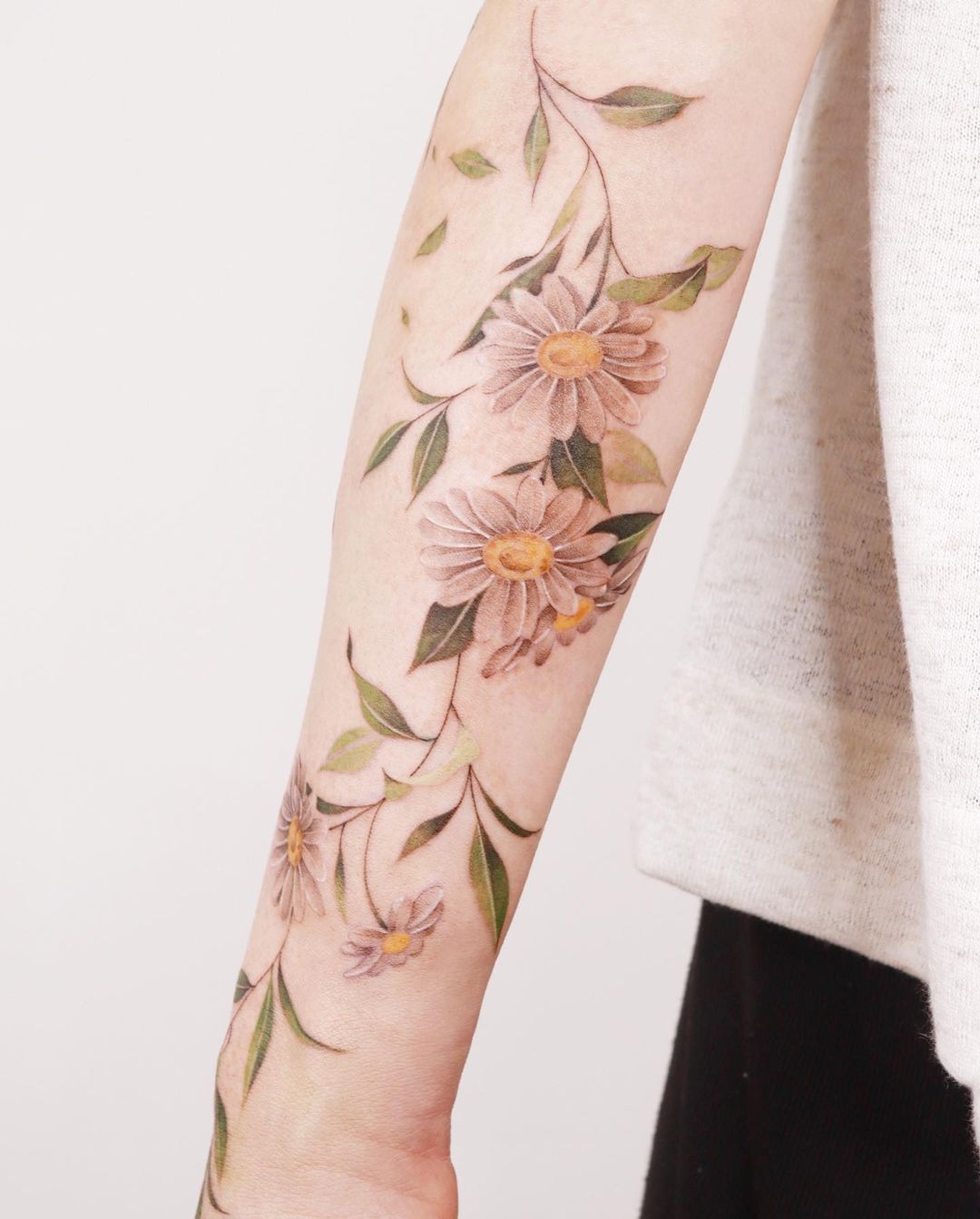 daisy on forearm tattoo by sozil tattoo