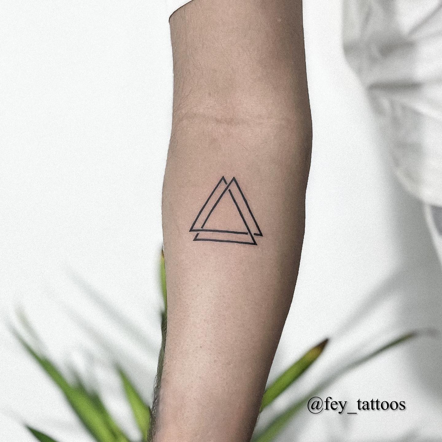 fineline triangle tattoo by fey tattoos