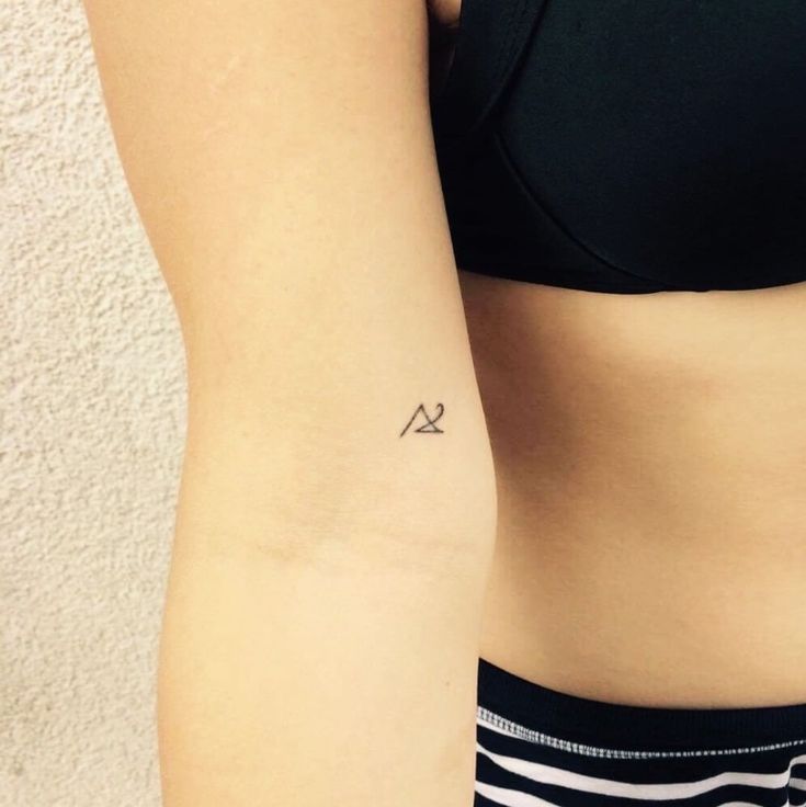 simple triangle tattoo on upper arm