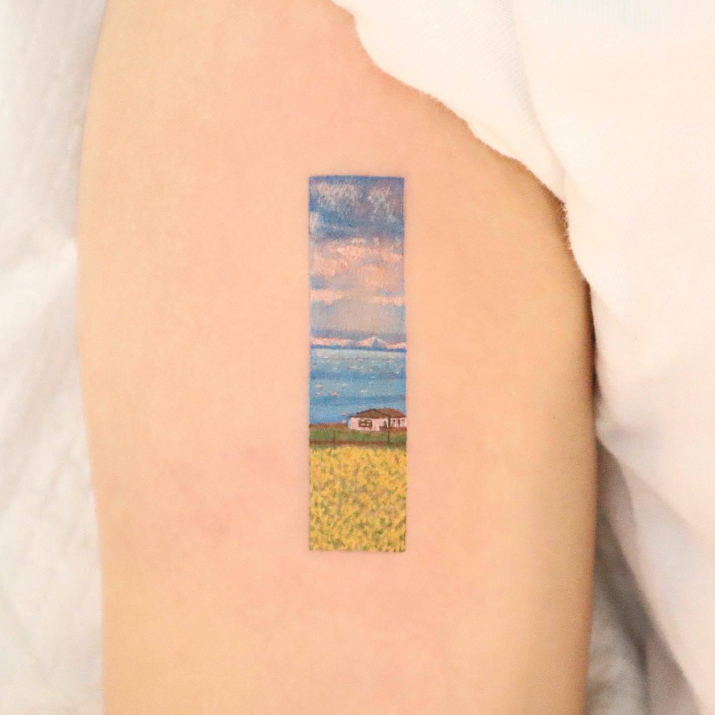 Realistic beach tattoo by suryeon.tt