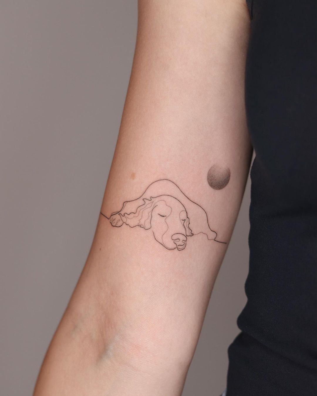 Upper arm dog tattoo by gaja tat