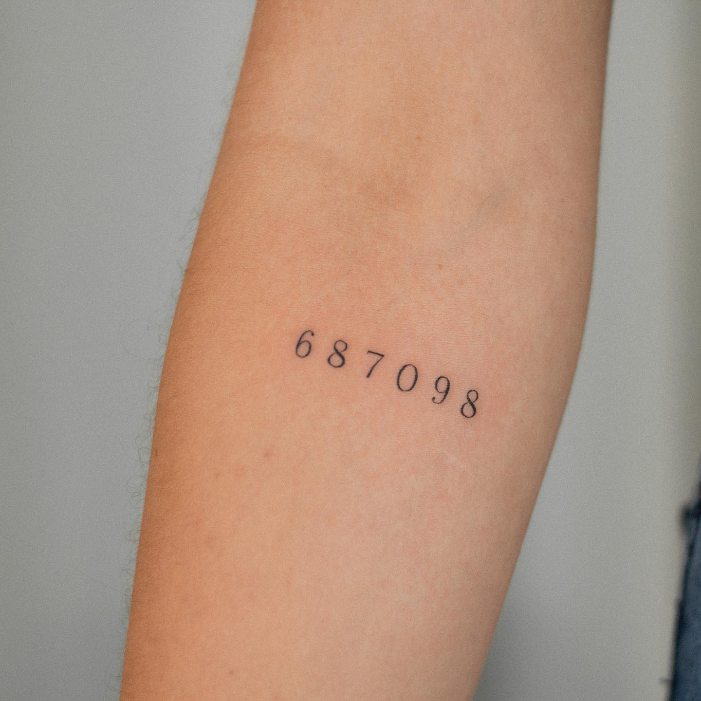 number tattoo on arm by botanink ko