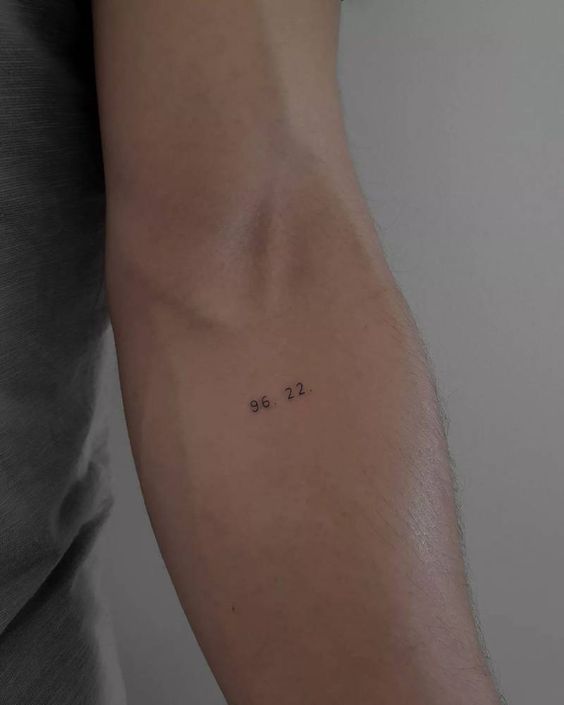 simple forearm number tattoo