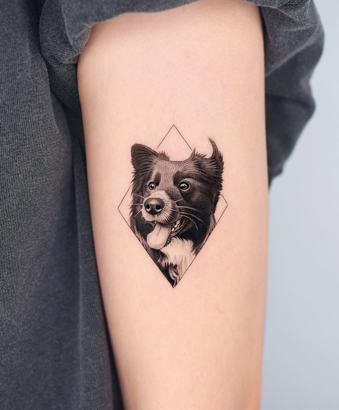upper arm dog tattoo by zeal tattoo