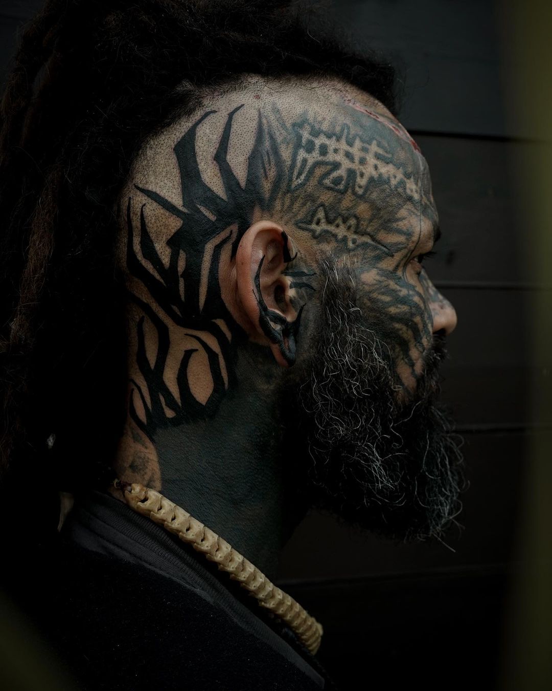 Black inked face tattoo design by maja.earth .tatu