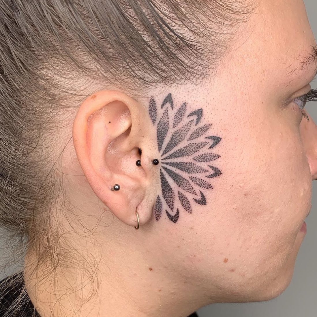 Small mandala face tattoo design by darkdaystattooer