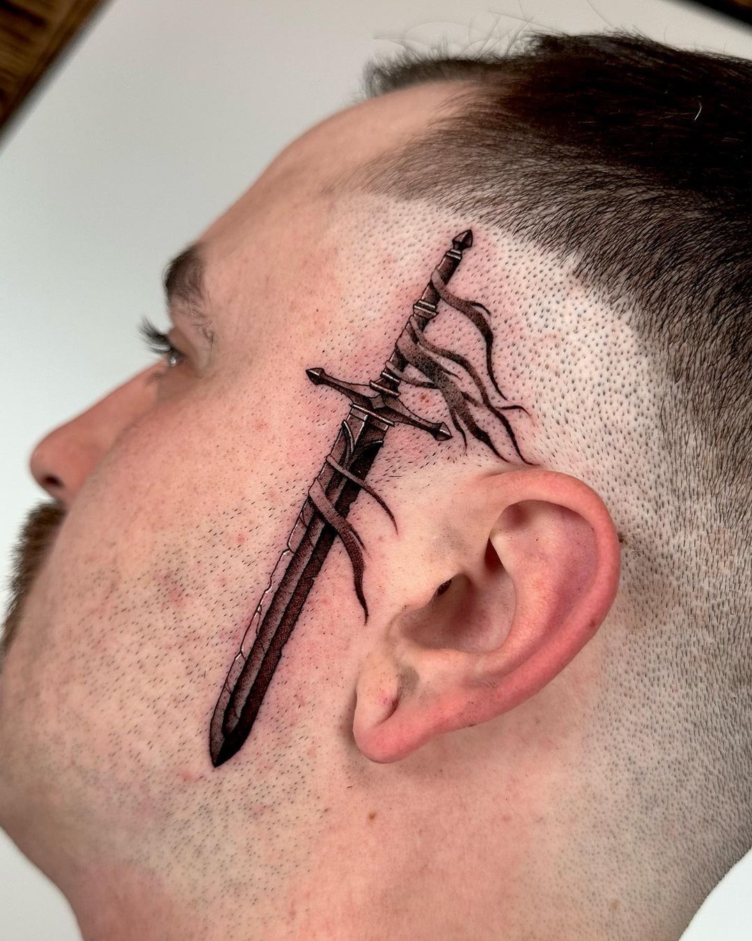 Sword face tattoo by camfontetattoos