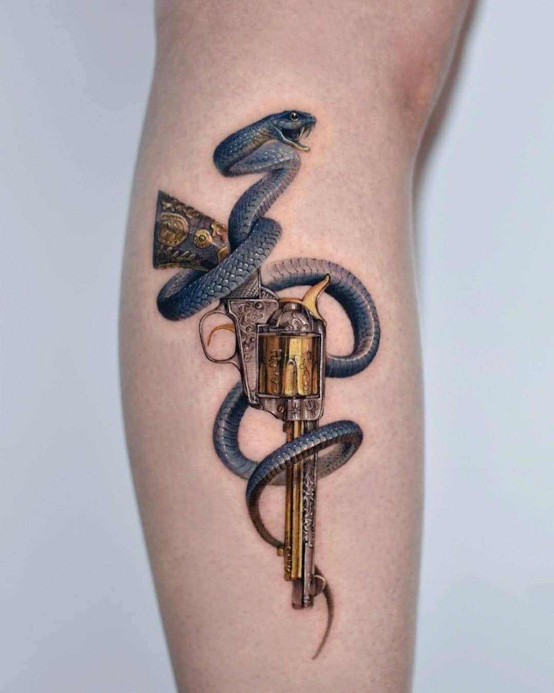 colorful gun tattoo by ink.traveler