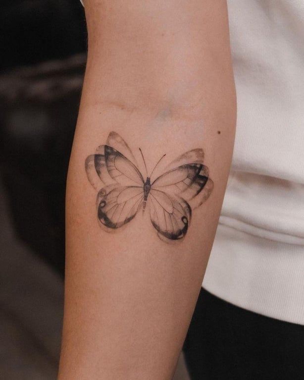 cute butterfly on arm tattoo