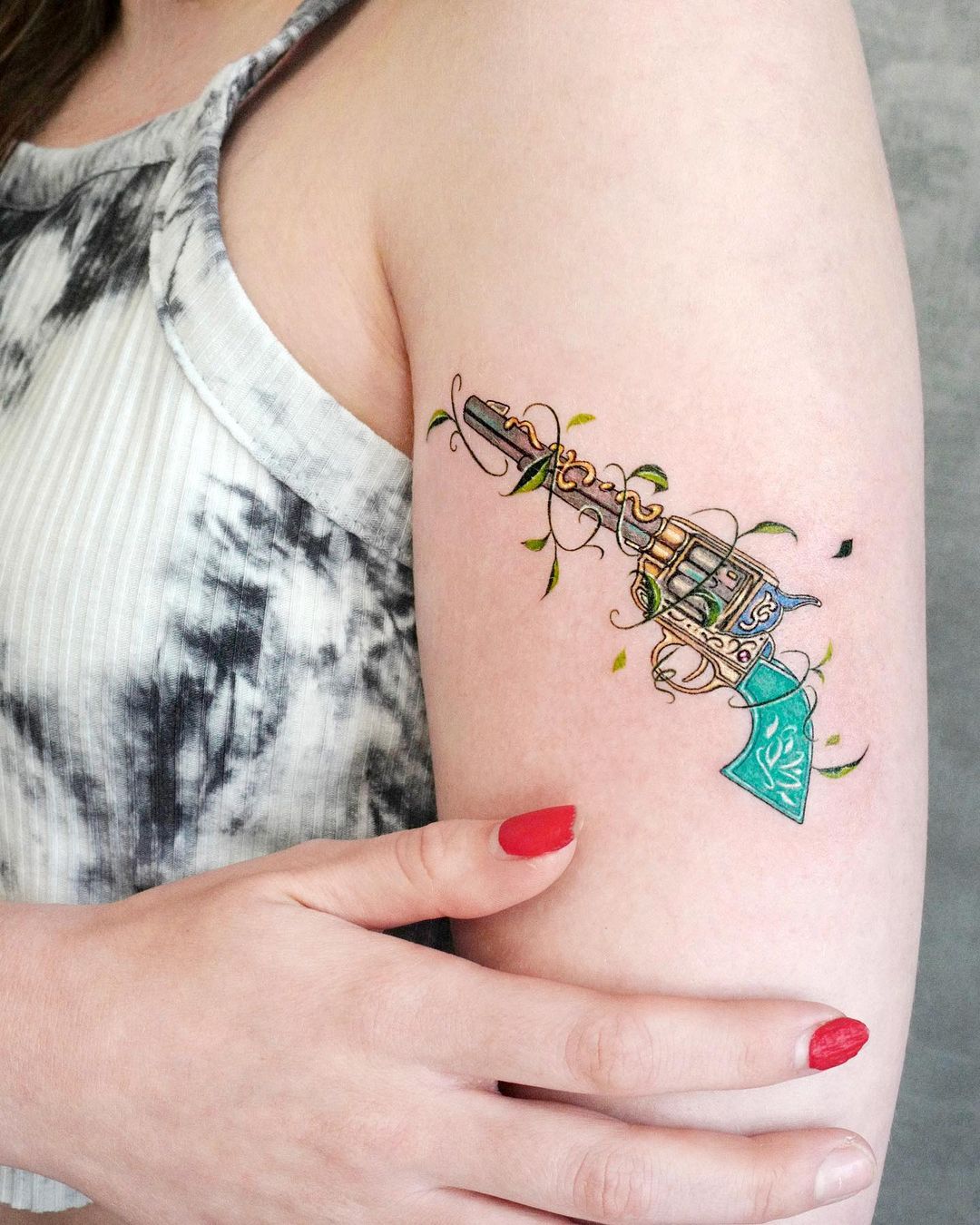 gun tattoo design for women by tattooist solar