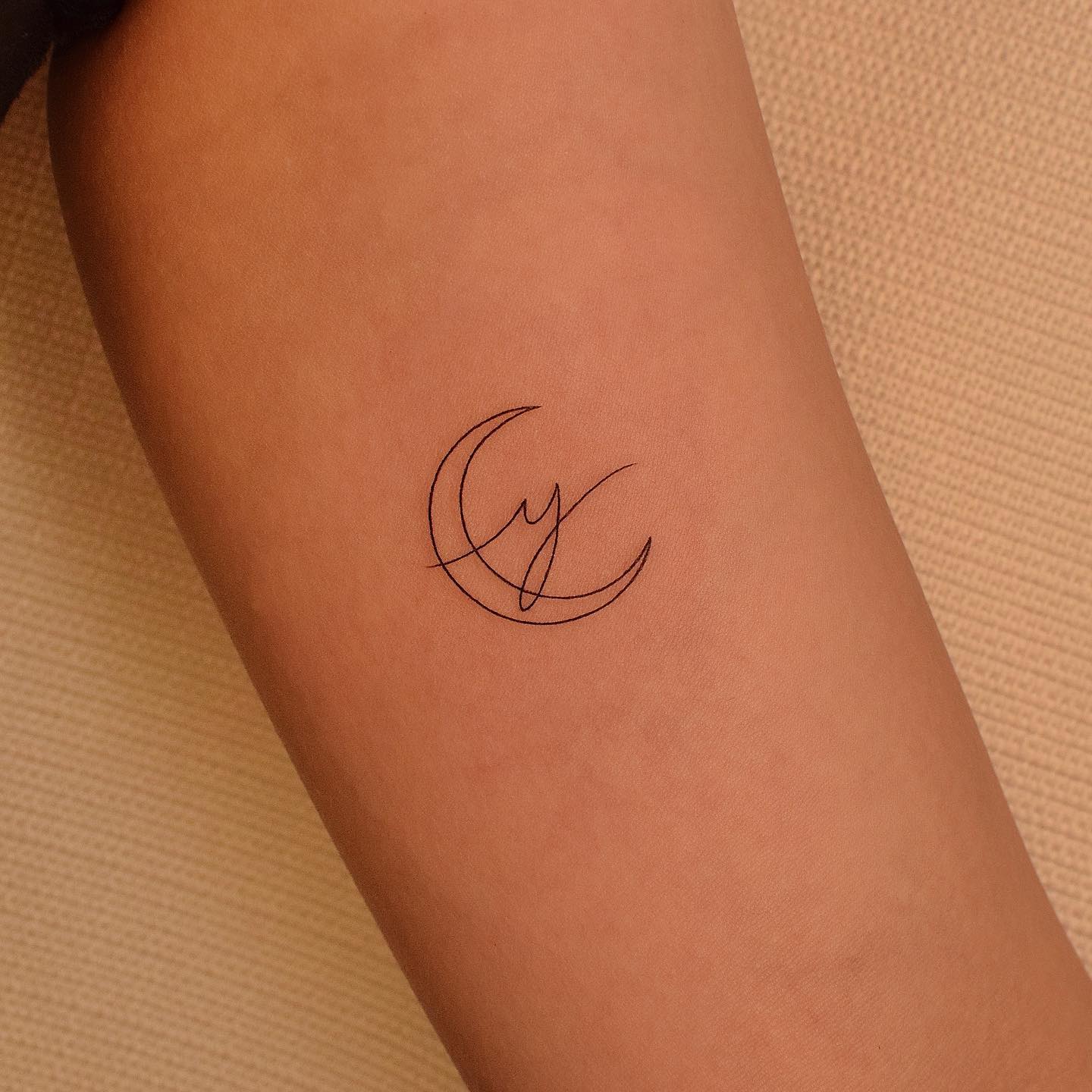 small and cute moon tattoo by tattooer jina