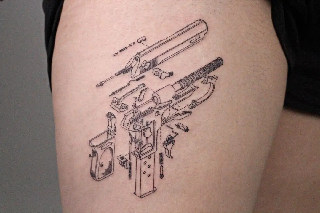 small gun design on thigh by tattooist arte