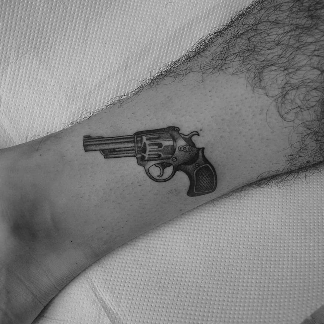 small gun tattoo by trazo sucio