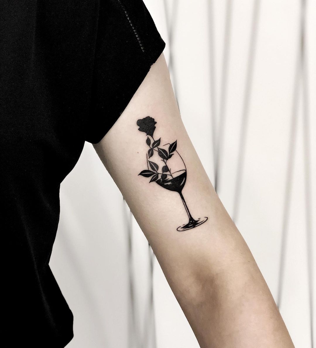 Black inked floral wine tattoo by ewowska