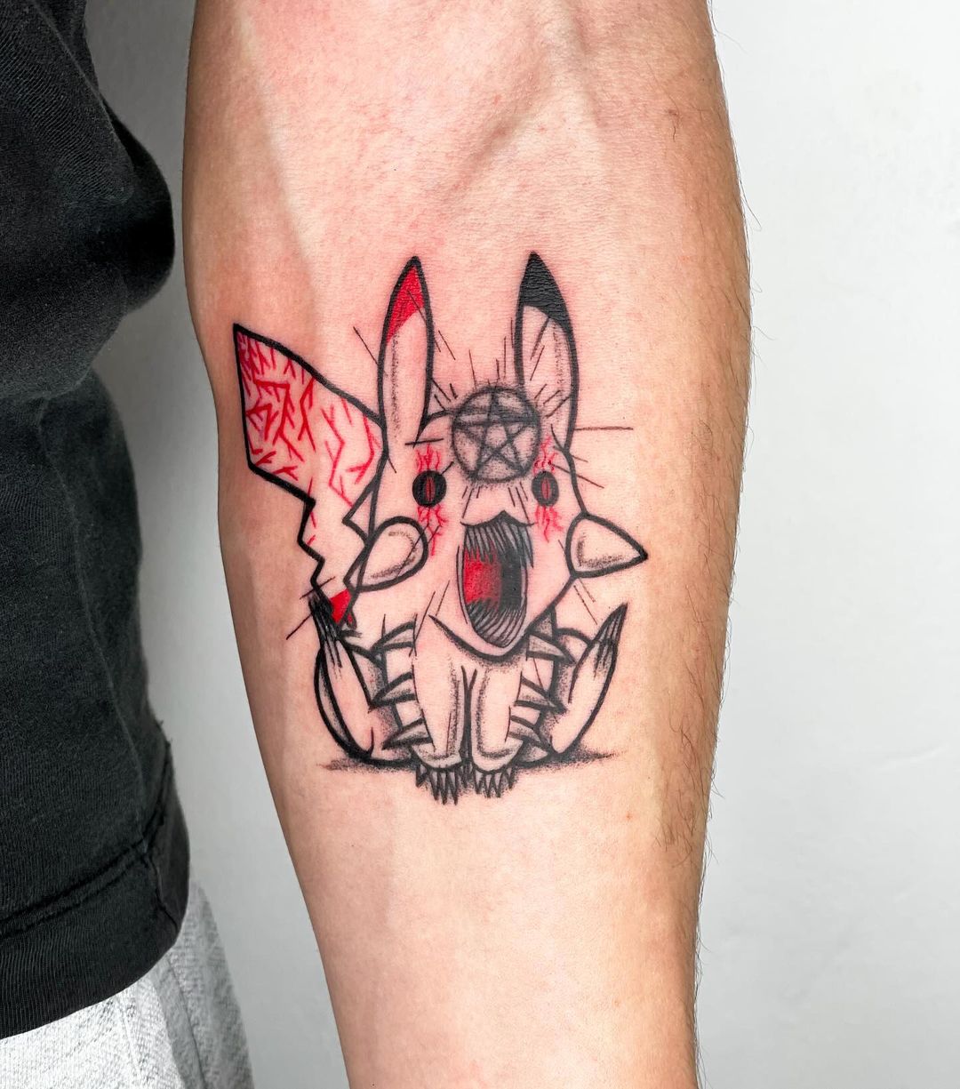 Pikachu tattoo on forearm by