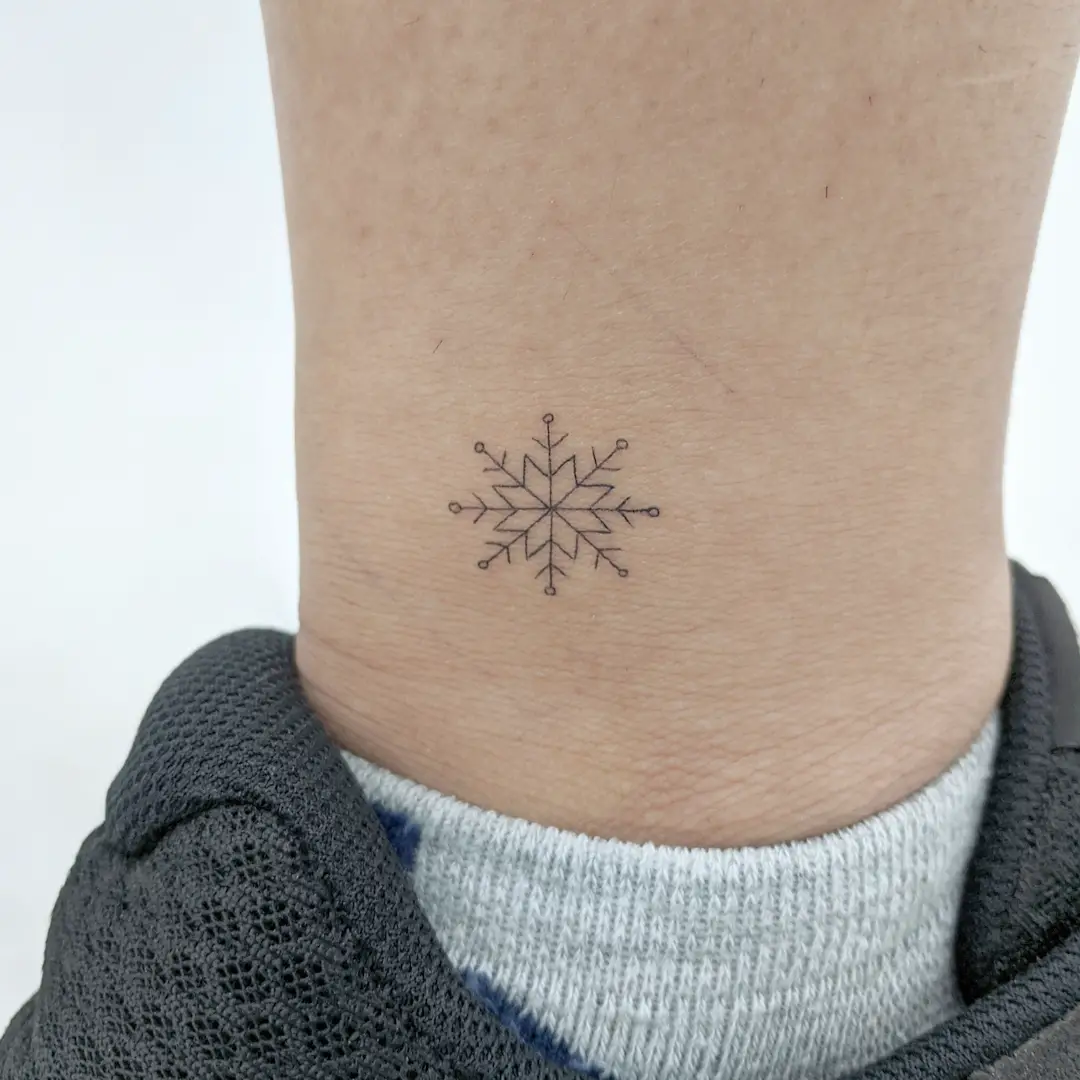 Small and cute snowflake tattoo for men by illisit