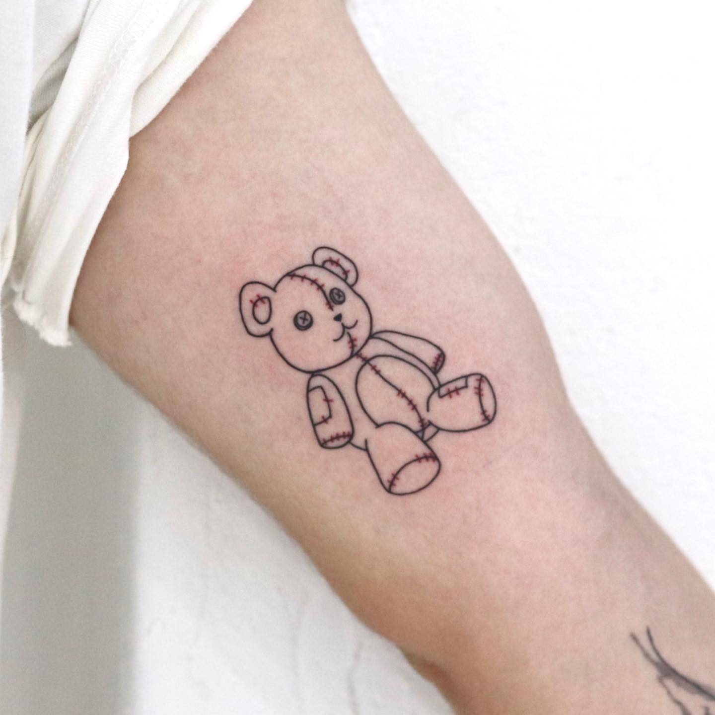 fineline teddy bear tattoo by yeonjae tattoo