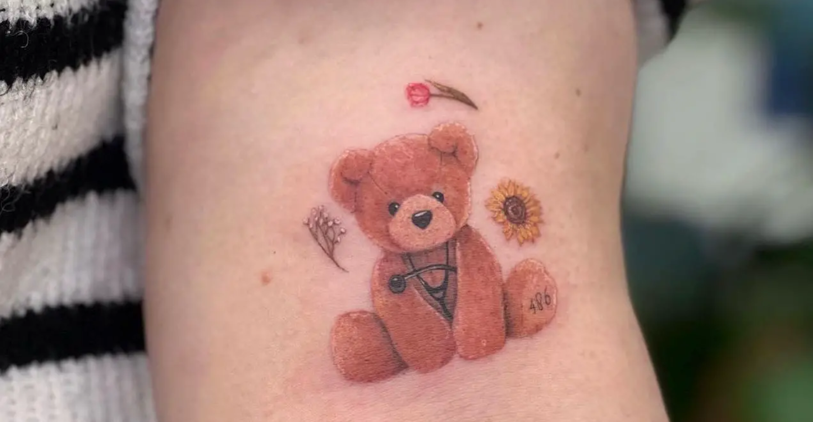 Fine line little teddy bear tattoo located on the inner
