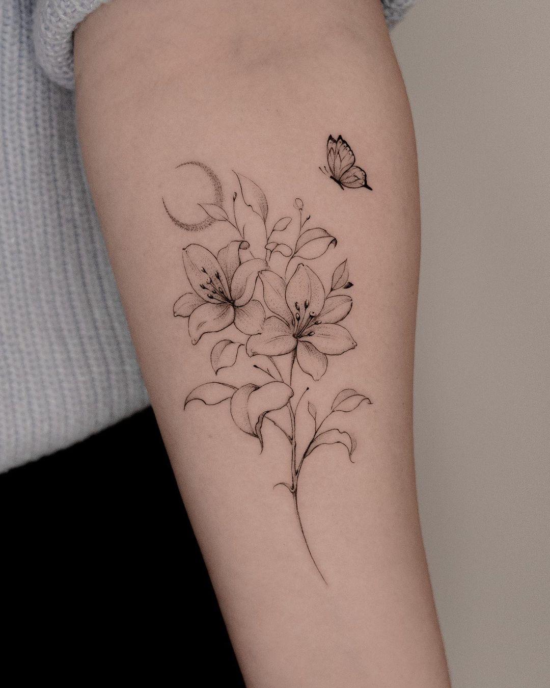 Fineline lily with butterfly tattoo by jk.tattoo