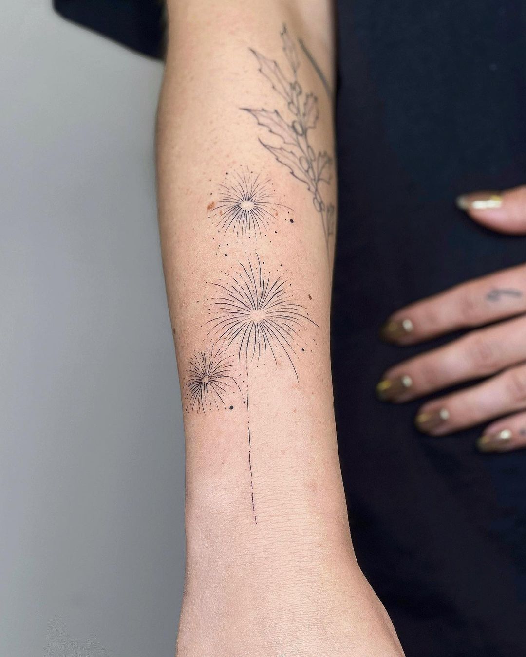 Firework tattoo on forearm by nothingwildtattoo