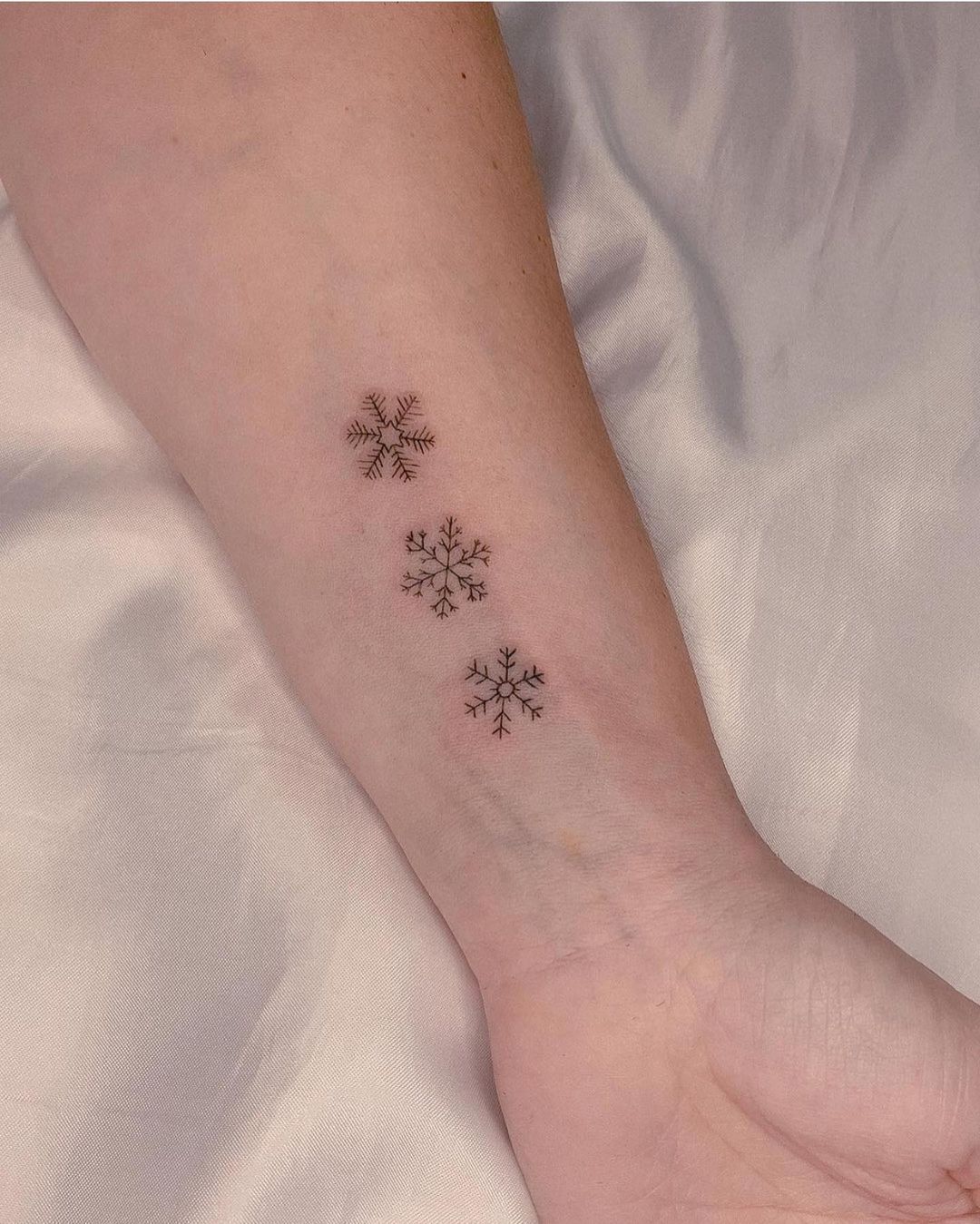 Tiny snowflake tattoo by ledstattoo