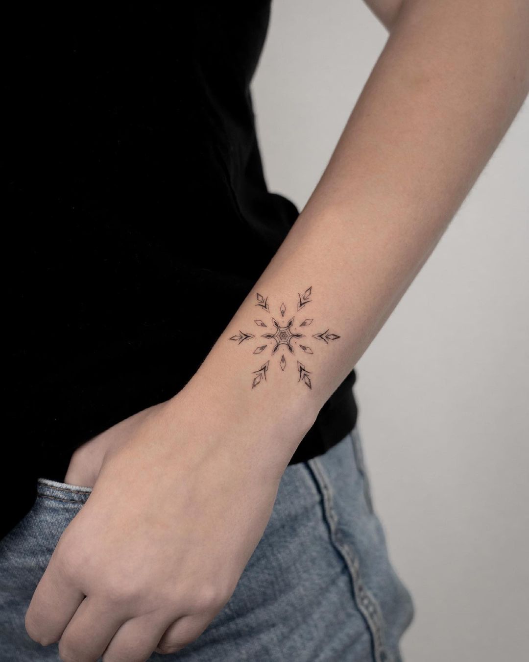 black inked snowflake tattoo by jk.tattoo