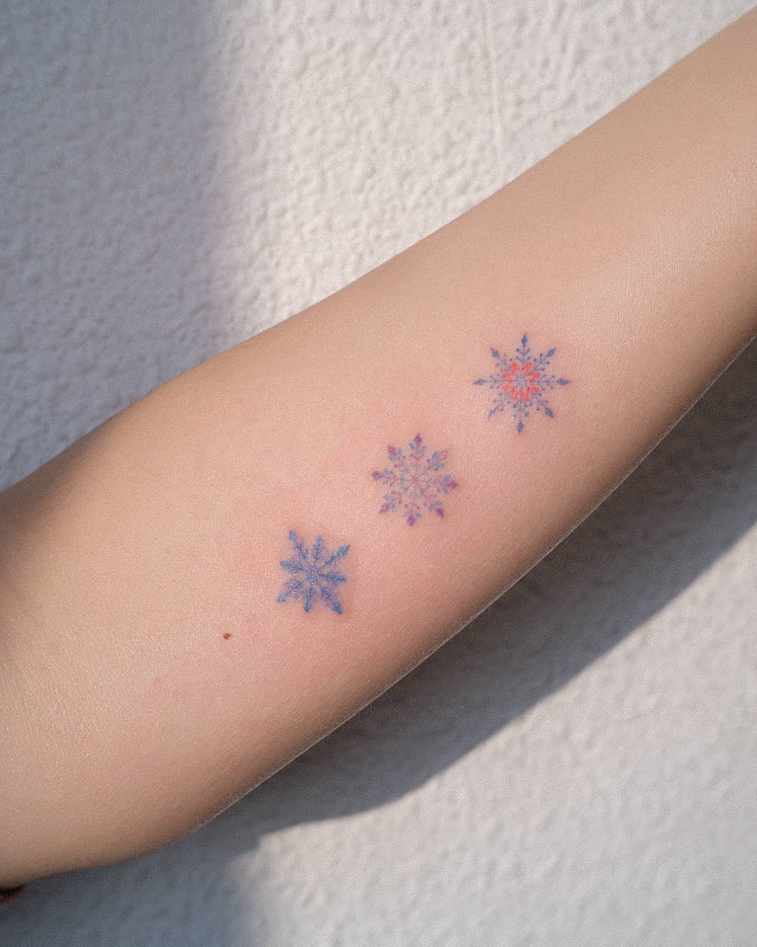 colored snowflake design by tattooistmuha