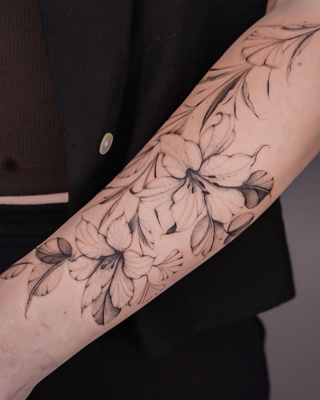 fineline lily tattoo on forearm by lasstattoo