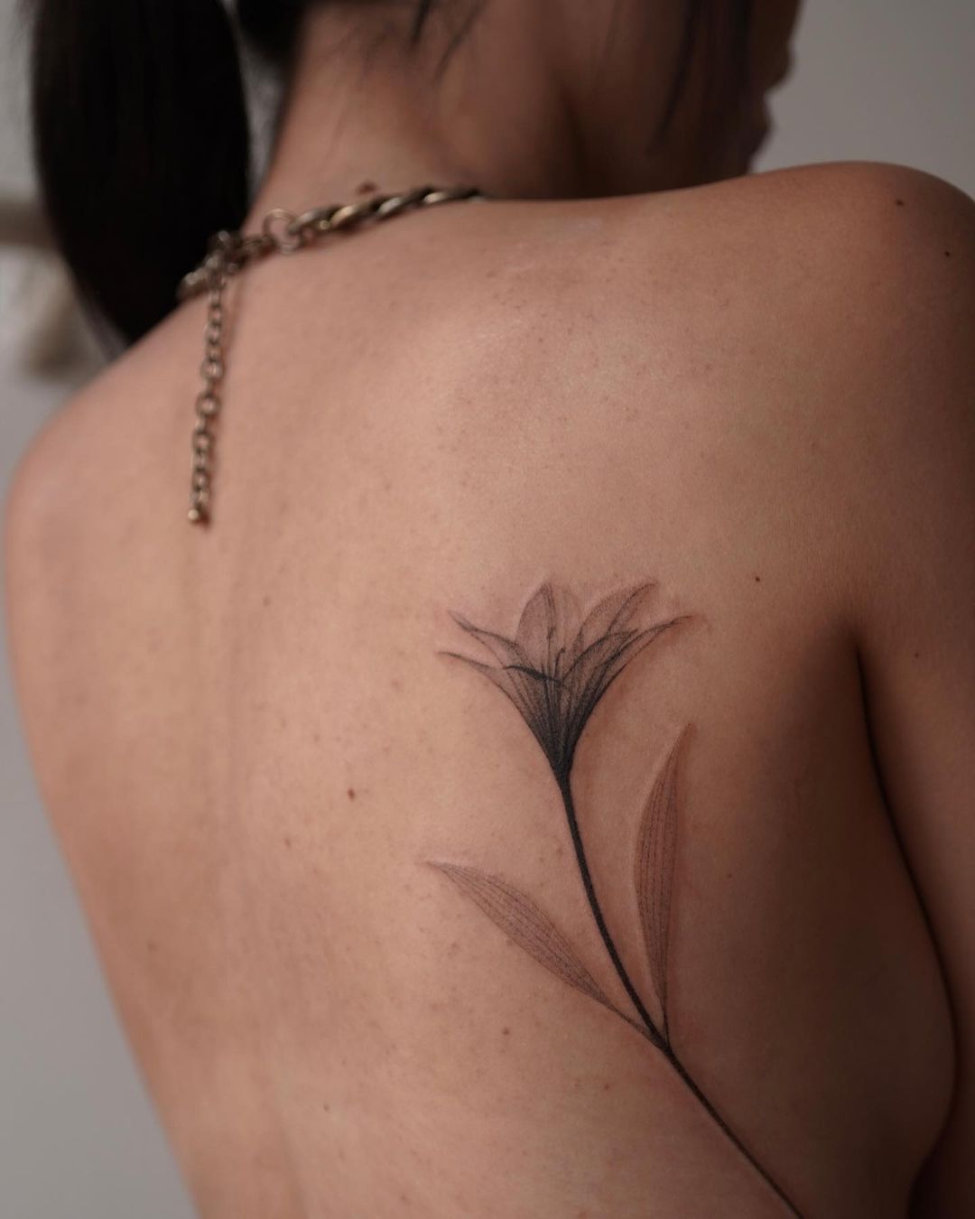 lily tattoo on back by kohld