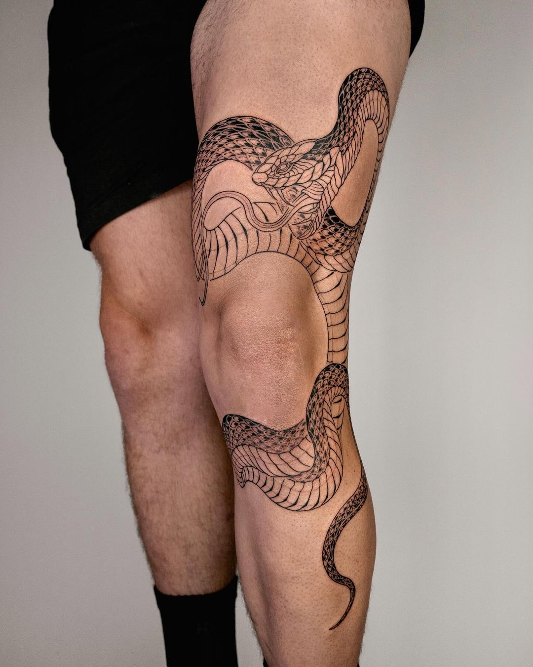 Snake on legs by saseultattoo
