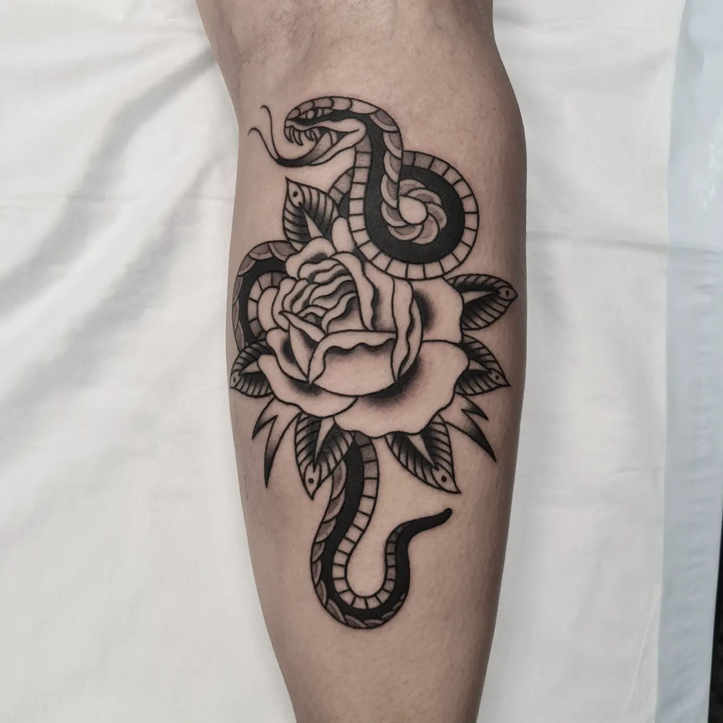 Snake with rose tattoo by cat tattoo