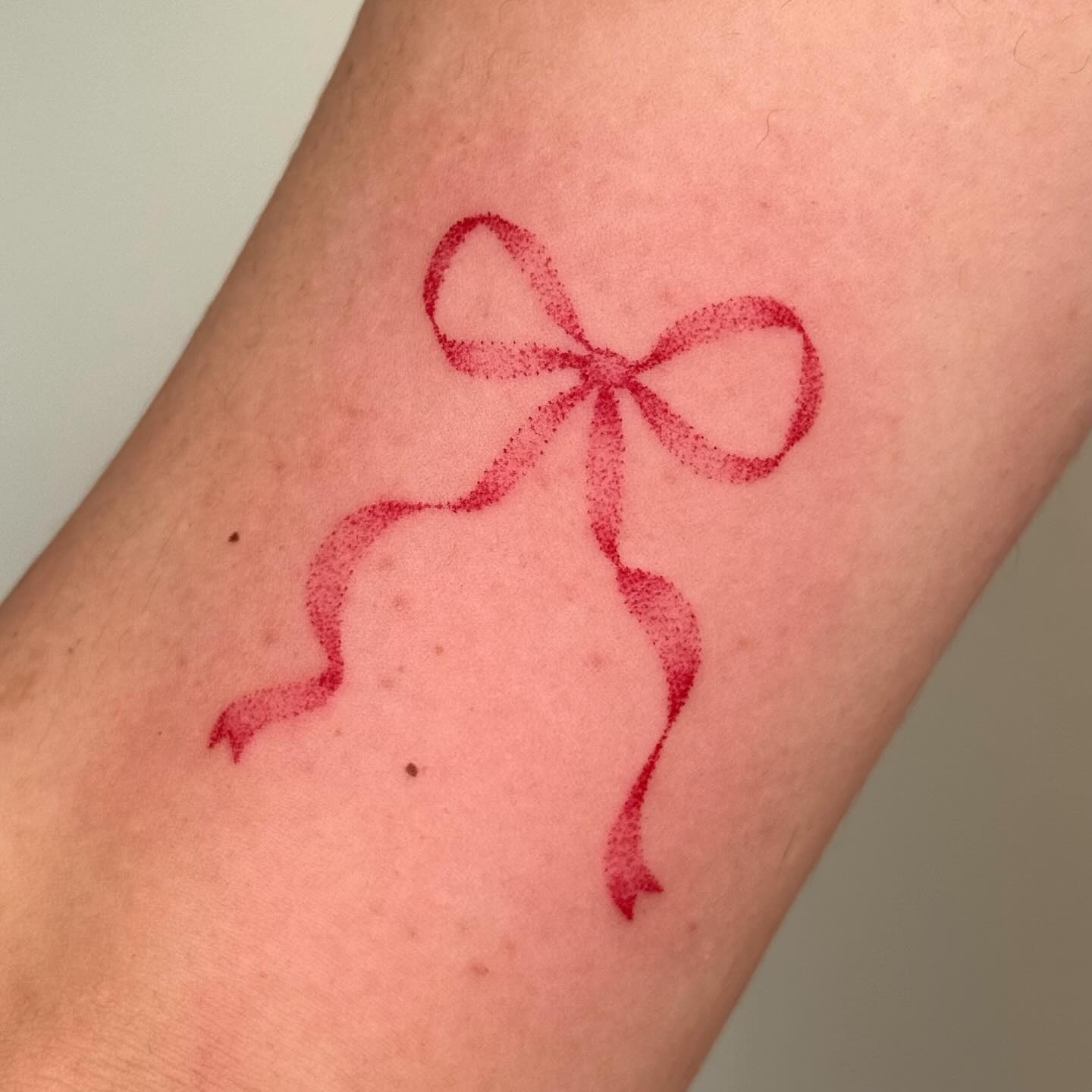 red tattoo on forearm by kiyodomo