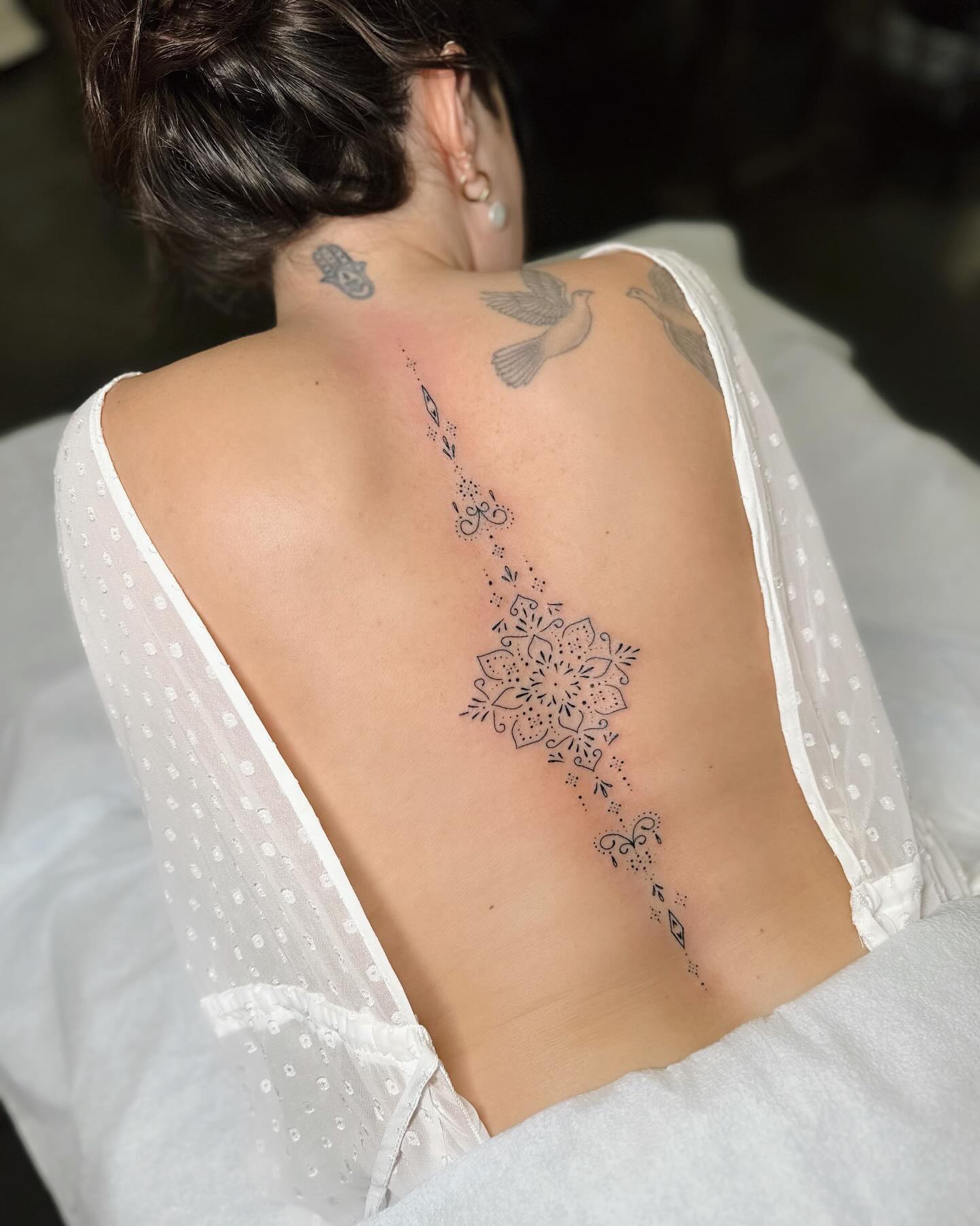Mandala spine tattoo by anais chabane