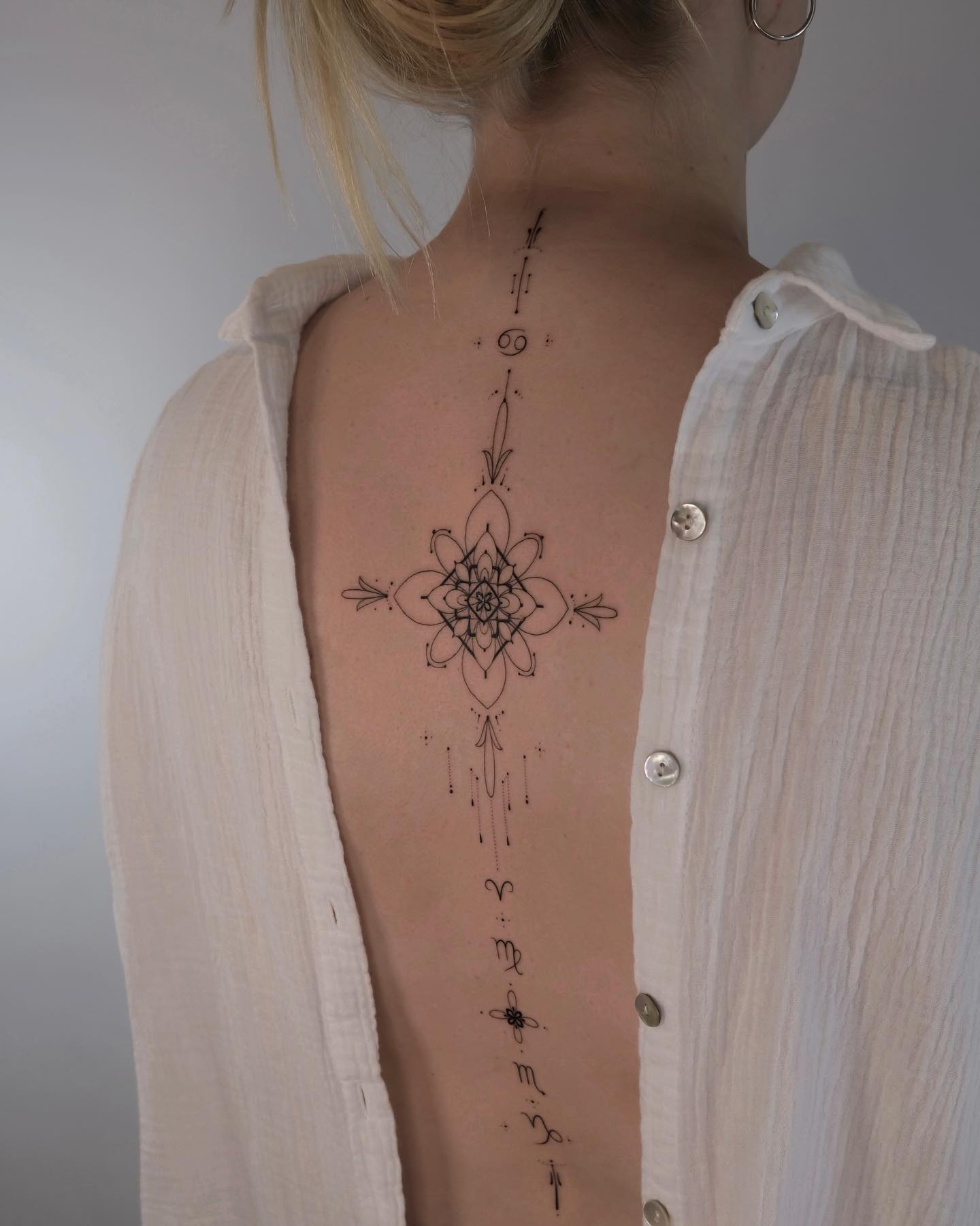 elegant spine tattoo by monochrom.ink