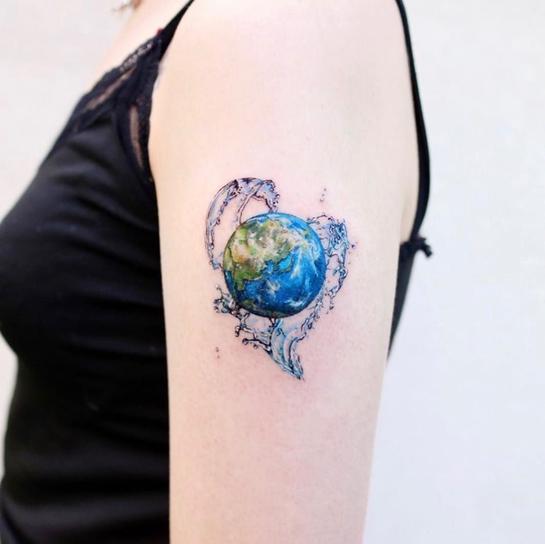 Earth tattoos on the upper arm by vismstudio