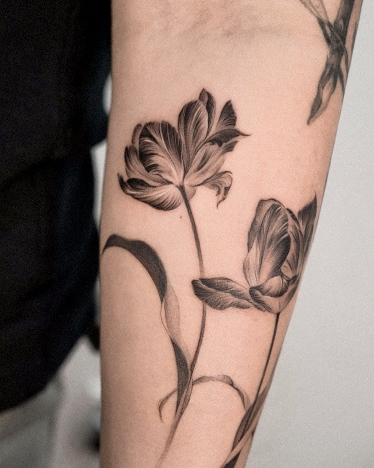 Black inked tattoos on the forearm by komi.tt